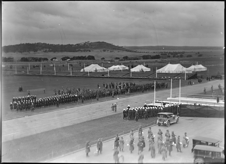 Royal Visit, May 1927. View from front of Parliament House looking east at troops, band, spectator stands and tents. Mount Pleasant in background.