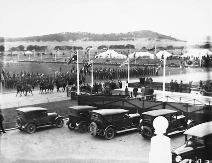 Royal Visit, May 1927 - Light horsemen riding past Army  troops outside Parliament House during rehearsal