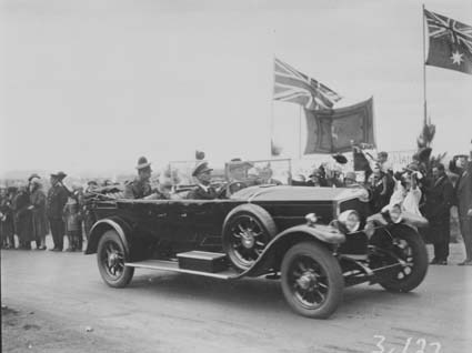 Royal Visit, May 1927 - Duke and Duchess of York in motor car passing a group of the Highland Society