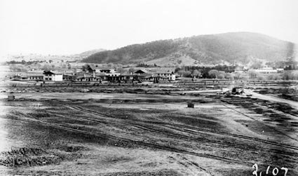 Parliament House to west towards Hotel Canberra and Commonwealth Avenue with landscaping in foreground