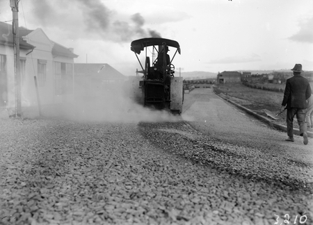Steamroller spraying tar in Mort Street, Canberra City.