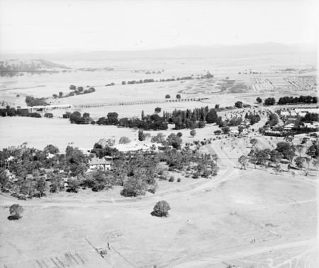 View across Acton and Commonwealth Bridge from the air. Bachelors Quarters in the trees.