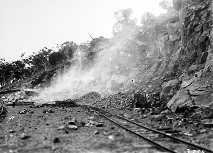 Brickworks quarry face with narrow gauge railway lines after an explosion