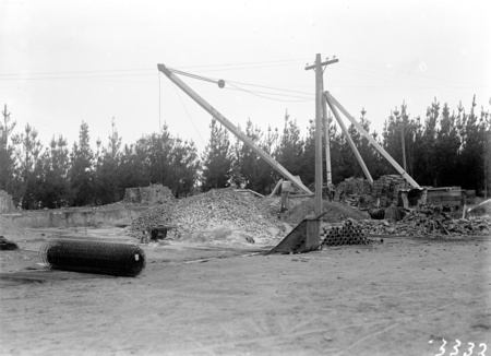 Building under construction at the Commonwealth Solar Observatory, Mt Stromlo, next to Administration Office showing crane marked 'W.H. Mason Builders Queanbeyan'.