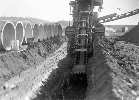 Parsons ditch digger excavating for concrete storm water drains.