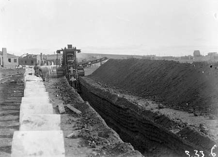 Parsons ditch digger excavating for concrete storm water drains.