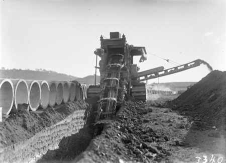 Parsons ditch digger excavating for concrete storm water drains.