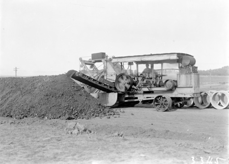 Parsons ditch digger excavating for concrete storm water drains.
