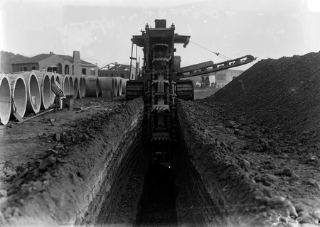 Parsons ditch digger excavating for concrete storm water drains.