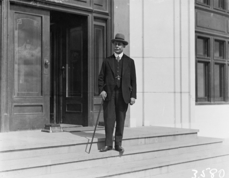 Hon Sir Littleton Groom on steps of Parliament House.