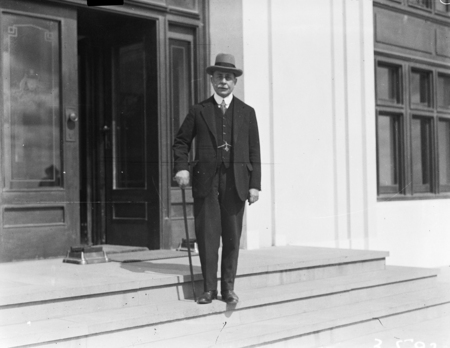 Hon Sir Littleton Groom on steps of Parliament House.