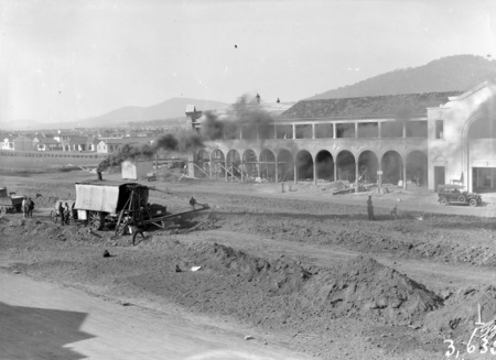 Part of Sydney Building Civic Centre under construction, from Melbourne Building showing Keystone steam shovel excavating Northbourne Avenue, left background is Canberra Times, Meyers Bakery, T.J.Sheeky, Cordial Factory in Mort Street, Ainslie.