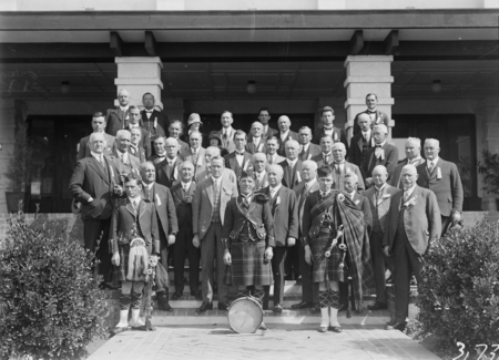 Canberra Highland Society with pipers and drummer, in front of Hotel Canberra.