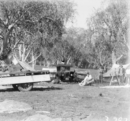 Surveyors camp with motor car and motor truck.