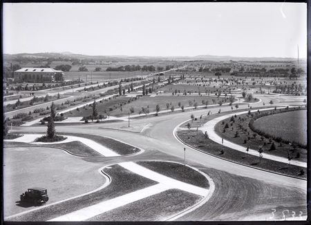 Commonwealth Avenue and Albert Hall from West Block showing young trees and roads.