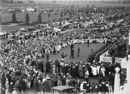  Bert Hinkler's welcome to Canberra by Prime Minister S.M.Bruce in front of Parliament House with large crowd of spectators