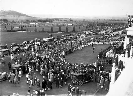  Bert Hinkler's welcome to Canberra by Prime Minister S.M.Bruce in front of Parliament House with large crowd of spectators