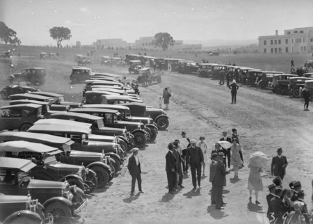 Lines of parked motor cars at welcome for arrival of Captain W.N. Lancaster and Mrs Keith Miller at the Review Ground opposite Hotel Kurrajong.