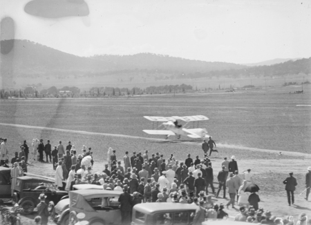 Captain W.N. Lancaster and Mrs Keith Miller landing their Avro Avian G-EBIO "Red Rose" at the Review Ground opposite Hotel Kurrajong.