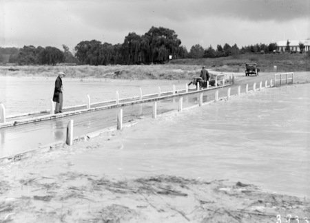 Floodwaters at Acton Crossing. Bridge rails removed.
