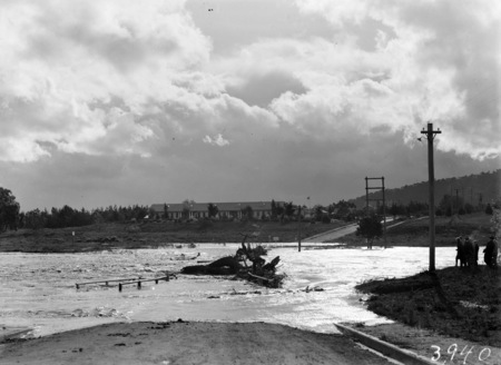 Acton Crossing showing destruction of bridge by floating logs and flood debris.