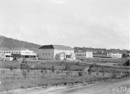 Manuka, showing Capitol Theatre, shops and Catholic Convent, Institution of Engineers commemorative tree planting in foreground.