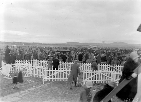 Visit of Kingsford Smith in Southern Cross - Part of the crowd and escorting aeroplanes