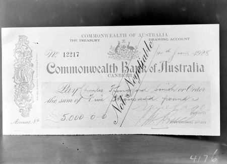 Cheque for Five thousand pounds presented  to Kingsford Smith, signed by Treasurer Dr Earle Page and the Prime Minister S.M.Bruce