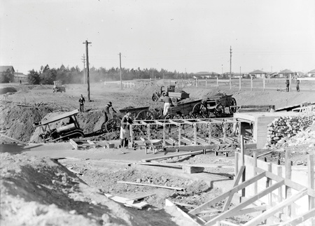 Tractor towing wagons on a contruction site near the Kingston Power Station