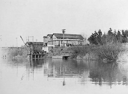 Kingston Power Station from the weir on the  Molonglo River,showing water  supply pipes .Used as a swimming  pool