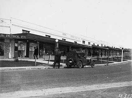 Giles Street Kingston looking South.Motor car being refuelled from petrol bowser. Post office and Savings Bank