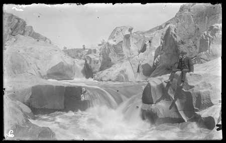 Waterfall with seated figure (possibly Sir John Butters) at Molonglo Gorge.
