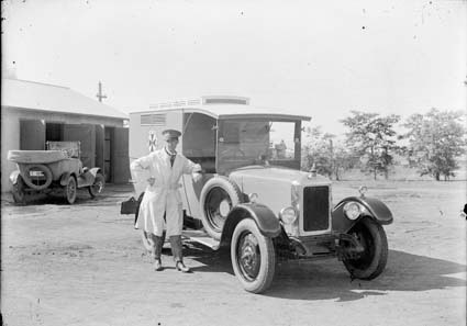 Motor ambulance van and driver, based in East Lake behind Kingston Power House. Driver wears uniform of early bus drivers