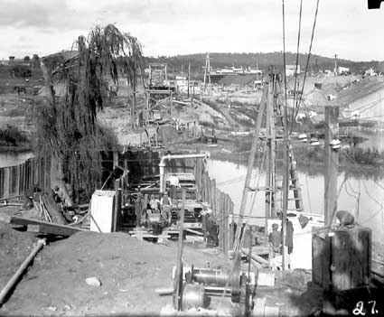 Excavation workings - Sewerage mains,under the Molonglo River. Hotel Canberra (background) and Commonwealth Bridge (right)