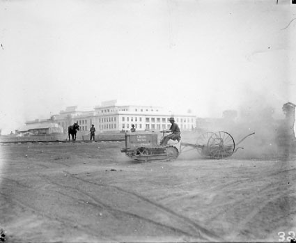 Parliament House opening preparations - Cletrac crawler tractor and scoop preparing the grounds - Light rail line in middle ground used to carry bricks from the brickworks to building sites