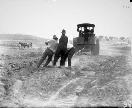 Steam traction engine towing a plough