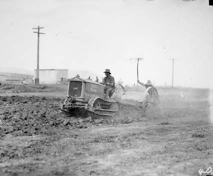 Cletrac crawler tractor hauling a scoop