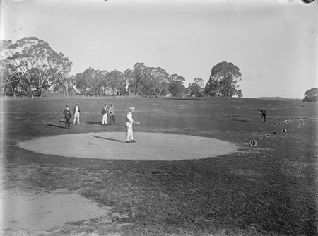 Six golfers on a green at the Canberra Golf Course.