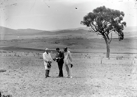 Prime Minister W M Hughes with  C S Daley Secretary to the Federal Capital Advisory Committee and P G Stewart Minister for Works and Railways on the site of Parliament House