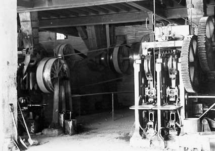Interior of Yarralumla brickworks showing brick presses for pressing clay bricks before firing - Note open drive belts and line shafting