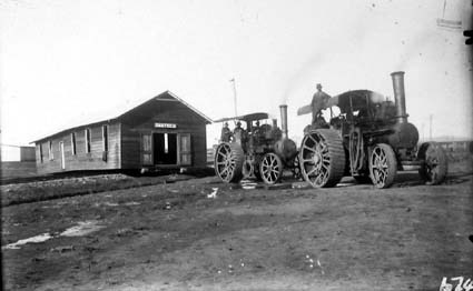Two traction engines hauling hut marked "CANTEEN" from the Molonglo Camp