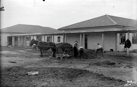 Gorman House, Ainslie Avenue , Reid,  under construction with drays and men - Walkway between buildings