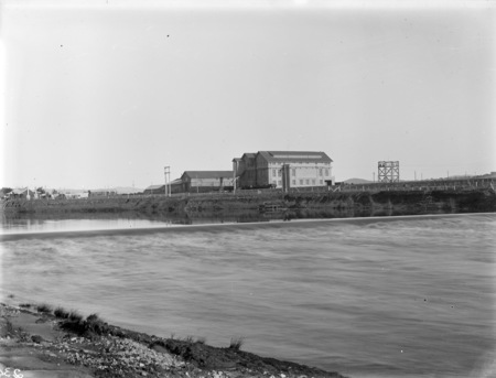 Kingston Power Station from the north bank of the Molonglo River, with weir in front.