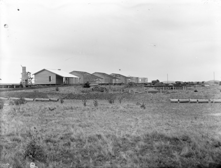 Weatherboard cottages under construction at Acton.