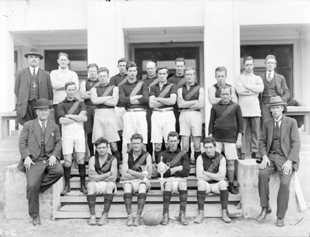 Australian Rules football team with officials.