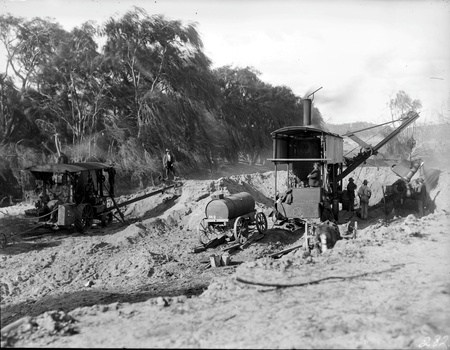 Two steam shovels with drays and water tank