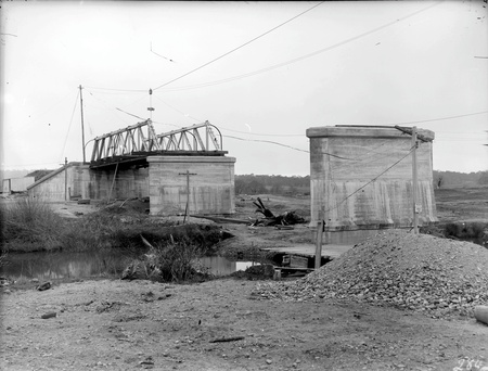 Commonwealth Avenue Bridge under construction showing flying fox for delivering concrete, etc to the pylons