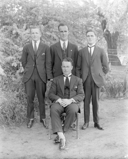 Four unidentified men (George O'Neill in the centre, standing).