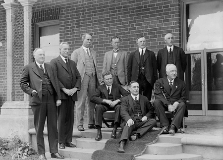Federal Cabinet (Bruce/Page) without Bruce at first meeting in Canberra at 'Yarralumla.' Sir Littleton Groom is sitting on the carpet.		