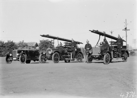 Canberra Fire Brigade with uniformed firemen and Appliances, one on the right is an Albion.